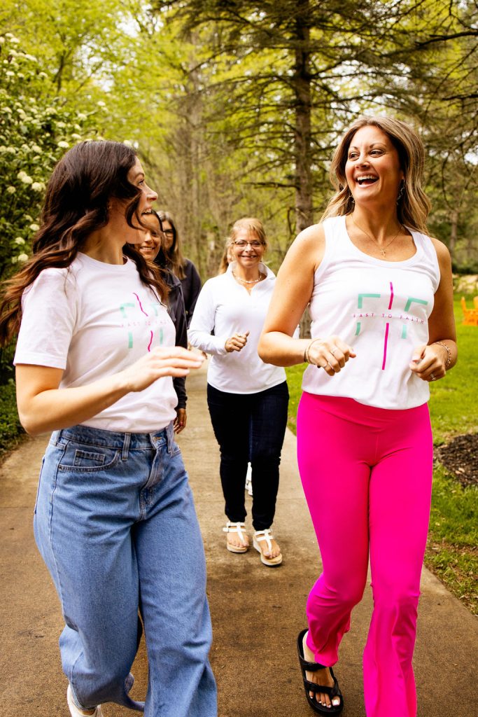 Fast to Faith coaches laughing and walking together outdoors